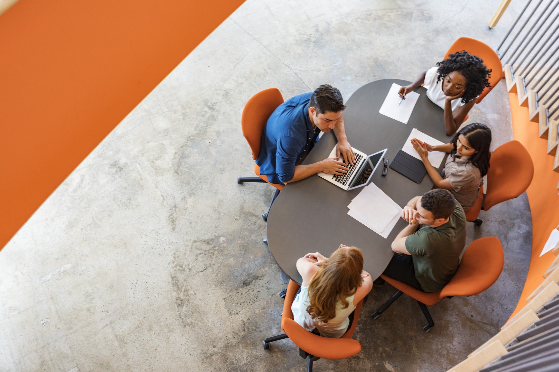 Top down view of a group of entrepreneurs working together in a business meeting